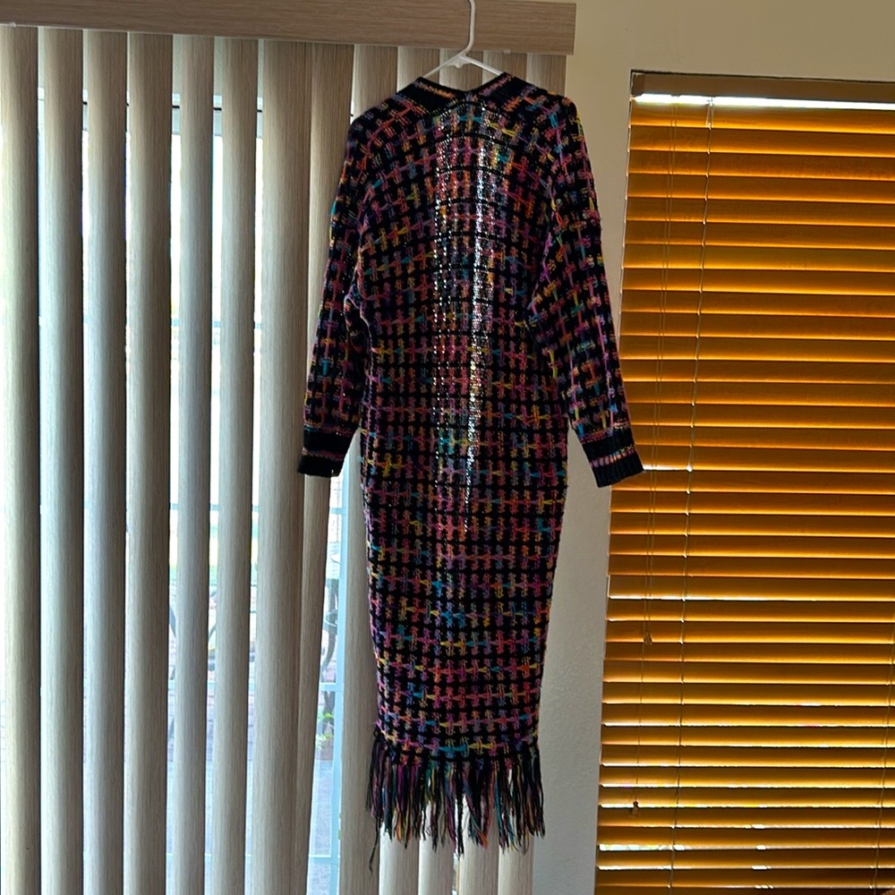This is a Size small and called the ‘Happy Cardigan.’  Lots of colors in it.